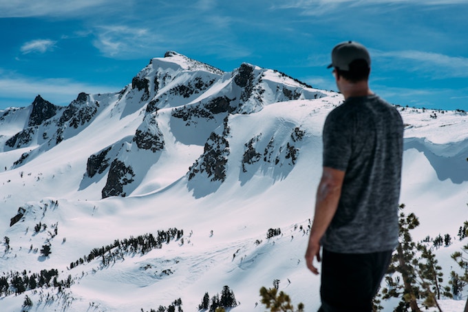 A man standing in view of Mammoth Mountain, California, USA