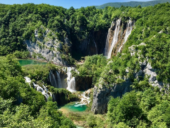 green trees and waterfalls during daytime