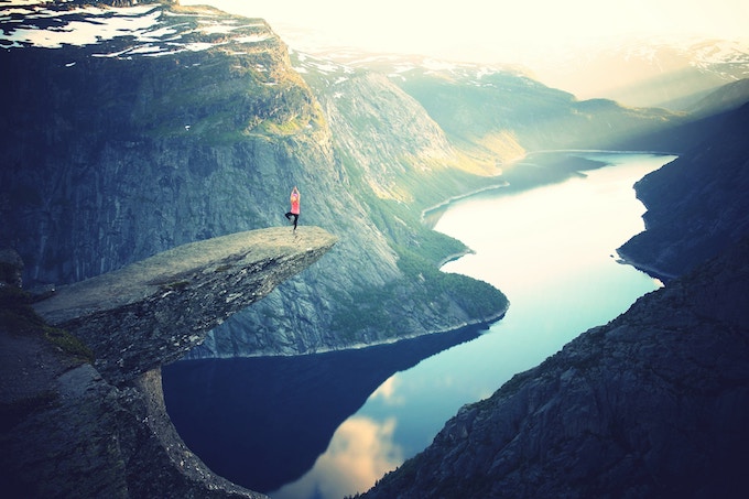 A woman posing on the tip of Trolltunga