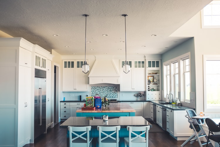 blue and white kitchen with island and table