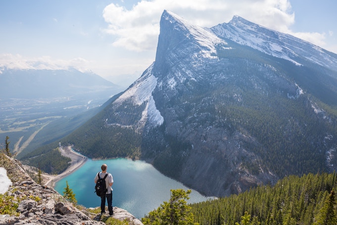 A person standing by a blue lake in Canada