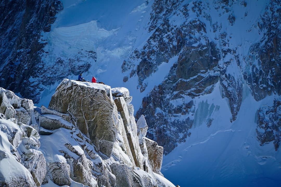 A man sitting on the top of a mountain in France