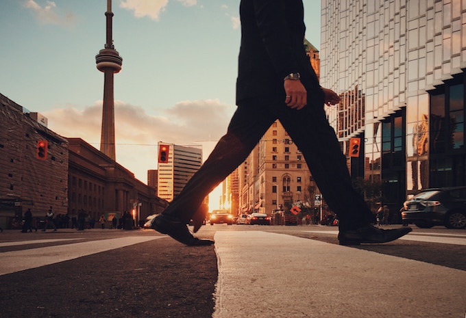 A man crossing the road in Toronto, Canada