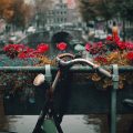 A bike resting against a canal bridge in Amsterdam