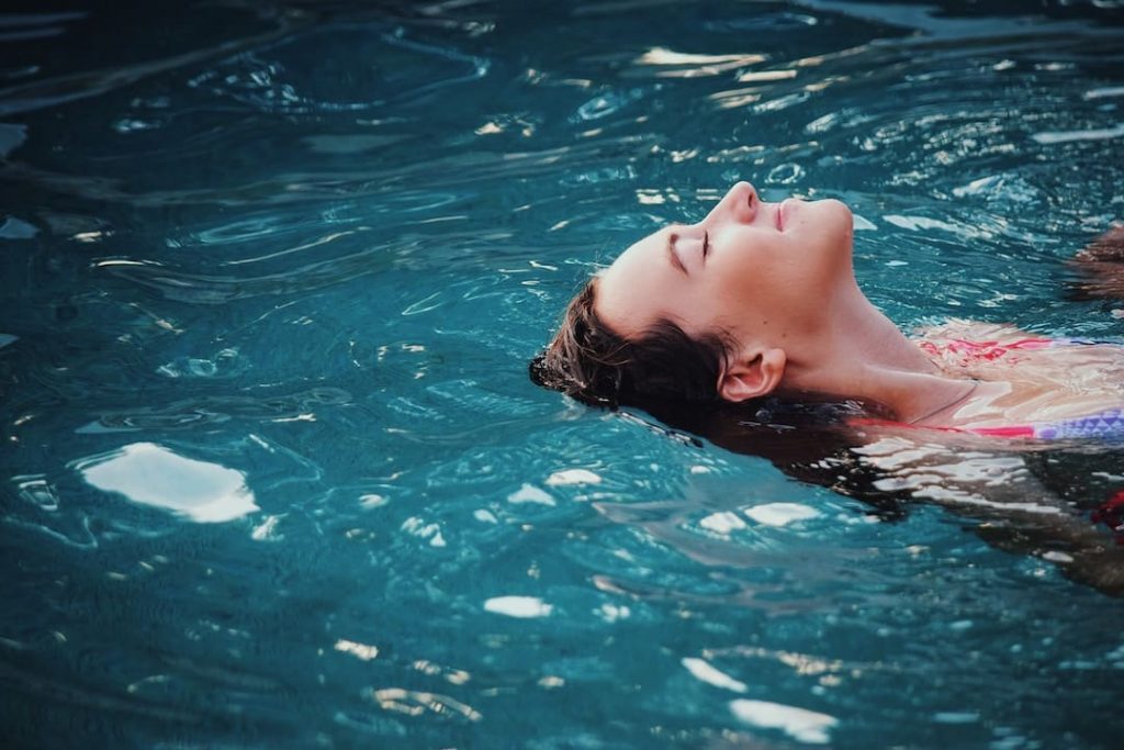 Woman floating in a pool at a spa