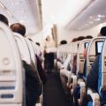 Flight attendant walking down the aisle on a flight