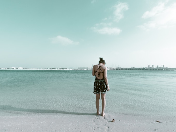 A woman standing on a beach in Dubai, UAE