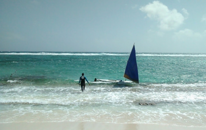 a man walking into the surf 