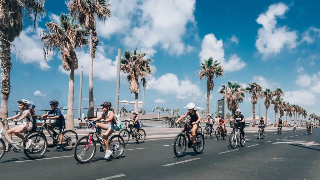 People cycling on a road in Tel Aviv