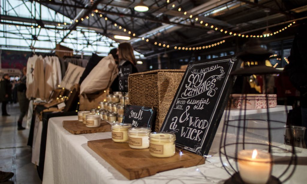 Vendor selling candles at the holiday market at Evergreen Brickworks in Toronto, Canada