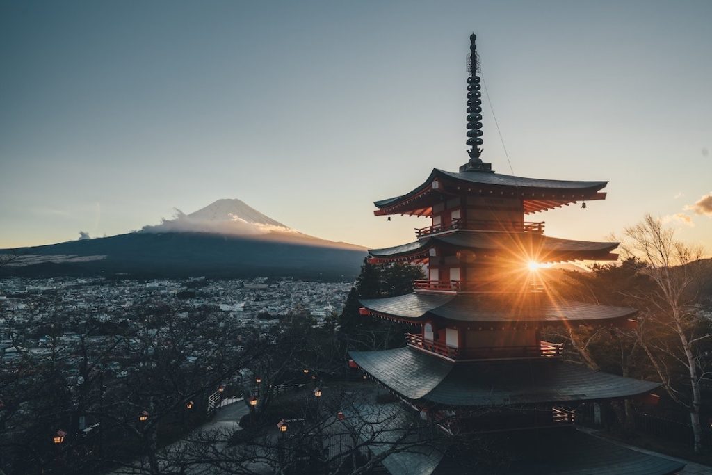 A view of Mont Fuji and a pagoda at sunset in Japan