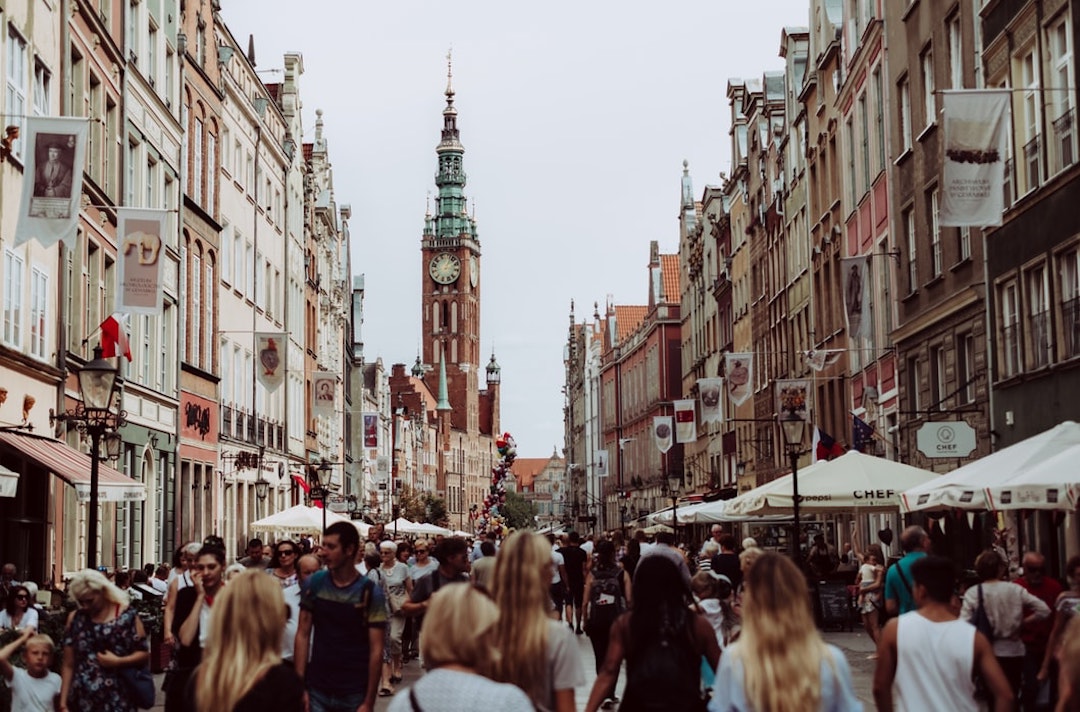 brown clock tower, a street full of busy people