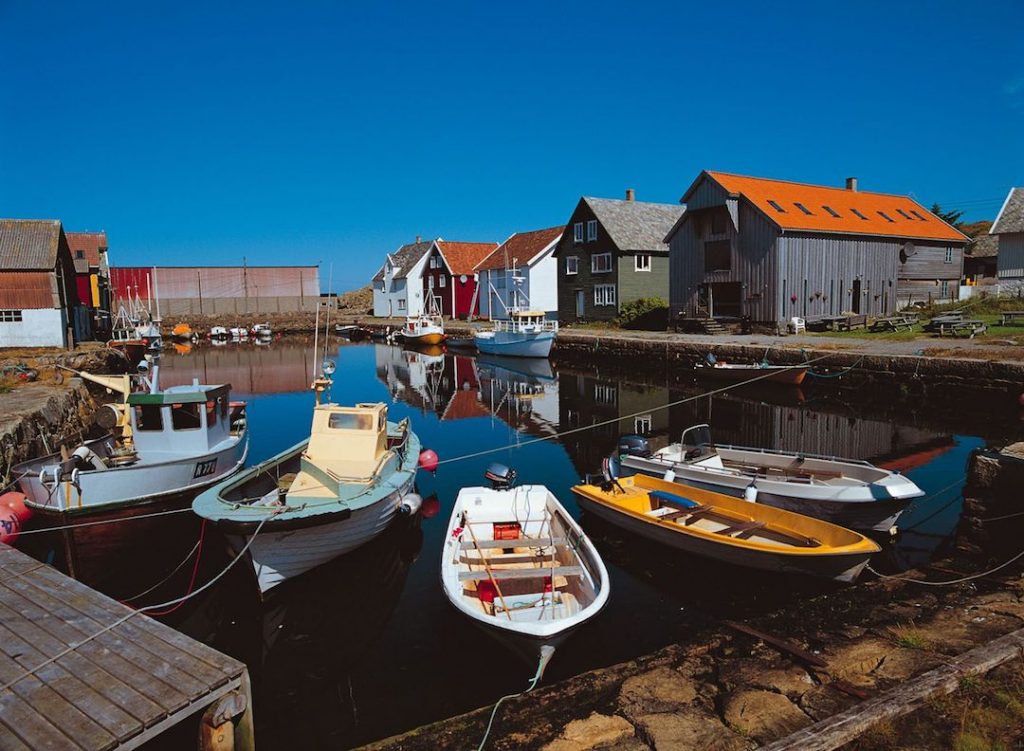 boats in a harbour and a small village