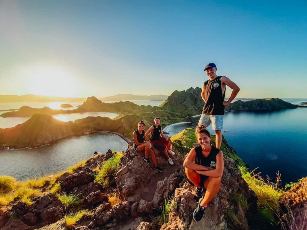 Group of travellers posing on a lookout point in Indonesia