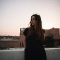 Woman looking to the right with Morocco scenery in the background