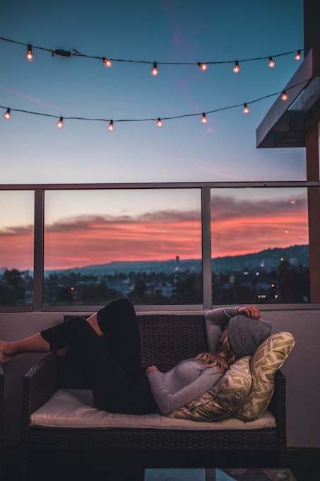 woman relaxing in a chair on the balcony