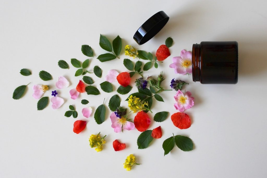 Cosmetic container with flowers and petals