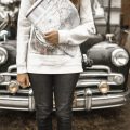 travel personality quiz: woman holding a map in front of her car