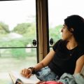 Woman on a bus looking out the window in East Africa