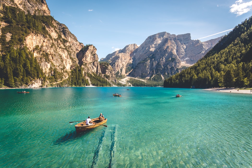 little boats sailing along a lake