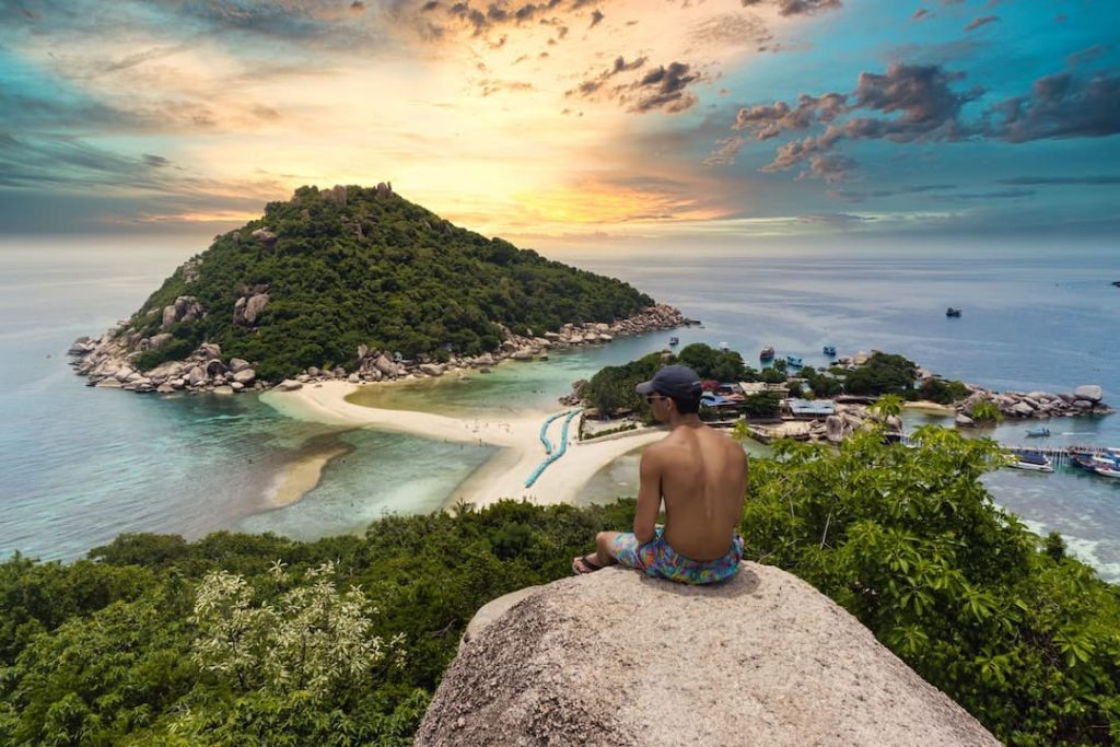 Person sitting at a lookout point on Koh Tao, Thailand