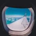 Airplane wing view out of plane window