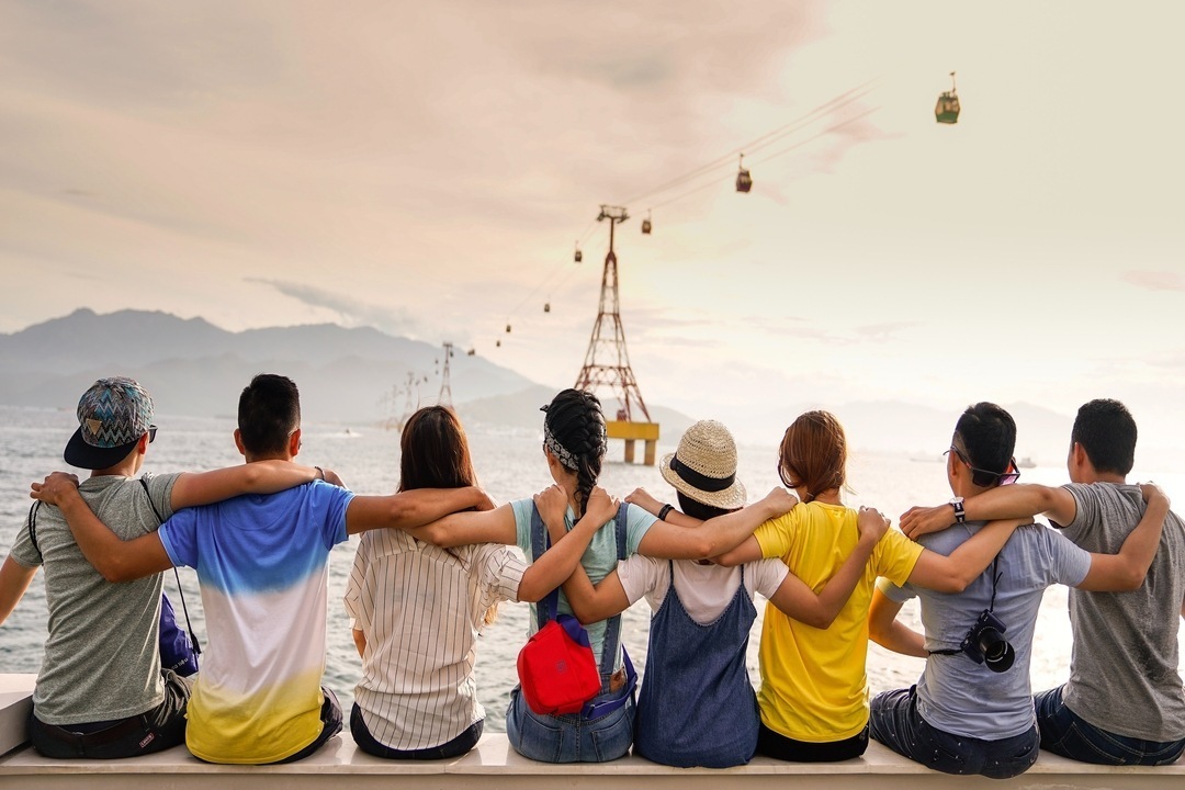 Friends sitting together staring at iconic landscape